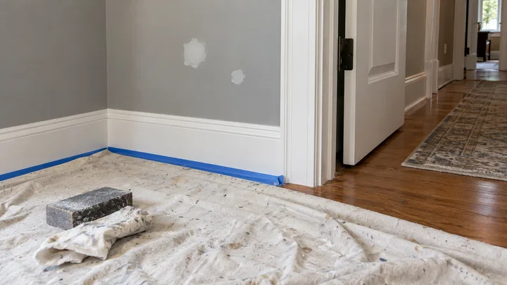 AI concept: interior trim masked and small wall repairs ready for paint